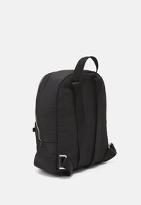 Black nylon backpack with padded sides, two adjustable straps, and a smooth zipper closure. Features a looped handle and silver hardware accents.