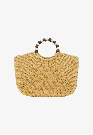 Geflochtene Strohtasche in Halbmondform, beige, mit einem runden, mit schwarz-weißen Perlen besetzten Griff.