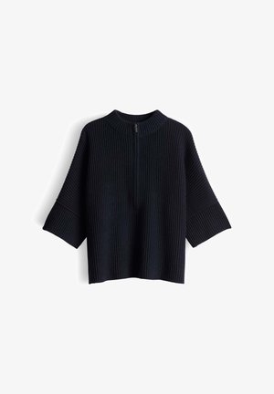 Black ribbed knit pullover with a high neckline, dropped shoulders, and wide sleeves. Features a half zipper at the front.
