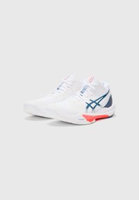 White athletic shoes with mesh upper, orange and navy accents, textured sole, and blue laces. Features ASICS logo on side and tongue.