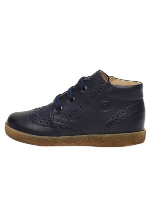 Navy blue leather ankle shoe with perforated decorative patterns, dark blue laces, and a textured light brown rubber sole.