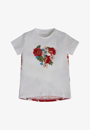 Hvid t-shirt med korte ærmer med blomsterdesign og guld paliet "GUESS ?" logo inden i en trekant foran.