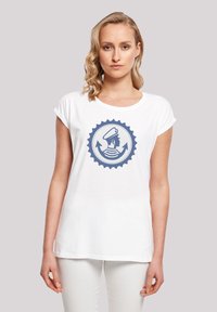 White cotton t-shirt featuring a circular blue graphic with a figure wearing a hat, surrounded by arrows and wavy lines. Crew neck design.