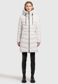 Long white puffer coat with a hood, featuring a zip closure, two side pockets, and black drawstrings. Smooth, quilted texture.