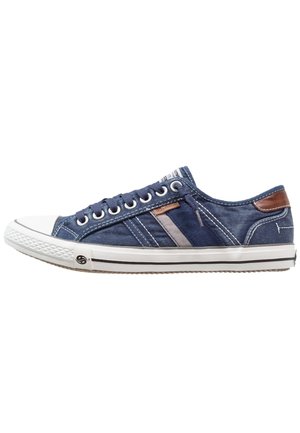 Low-top navy blue canvas sneaker with white rubber sole, white toe cap, black stripe details, brown heel patch, and blue laces.