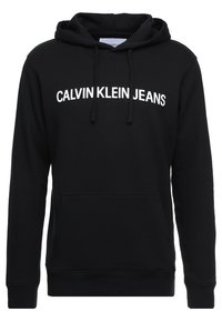Sudadera negra de algodón, con un bolsillo canguro frontal y el texto blanco "CALVIN KLEIN JEANS" impreso en el pecho.