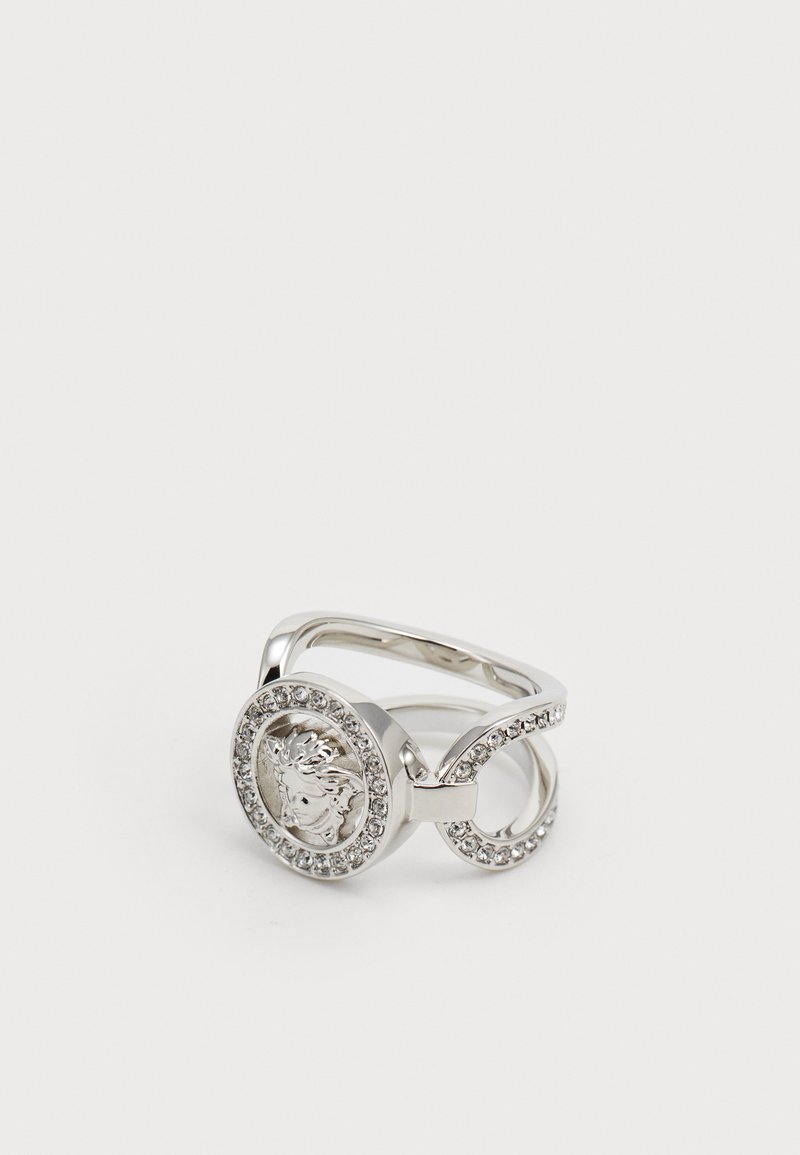 Silver ring featuring a central circular design with an embossed lion head, surrounded by clear rhinestones, with a smooth band.