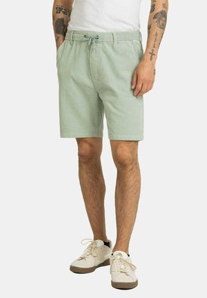 Hellgrüne Shorts aus Baumwolle mit einem elastischen Bund und Kordelzug, seitlichen Taschen und einer lockeren Passform.