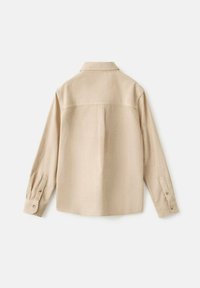 Beige Langarmhemd aus strukturiertem Stoff, mit Kragen, durch Knöpfe verstellbaren Manschetten und einem Schulterdesign auf der Rückseite.