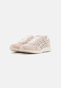 Light pink suede and mesh sneakers with white laces and accents. Metallic silver stripes on sides and a textured white sole.
