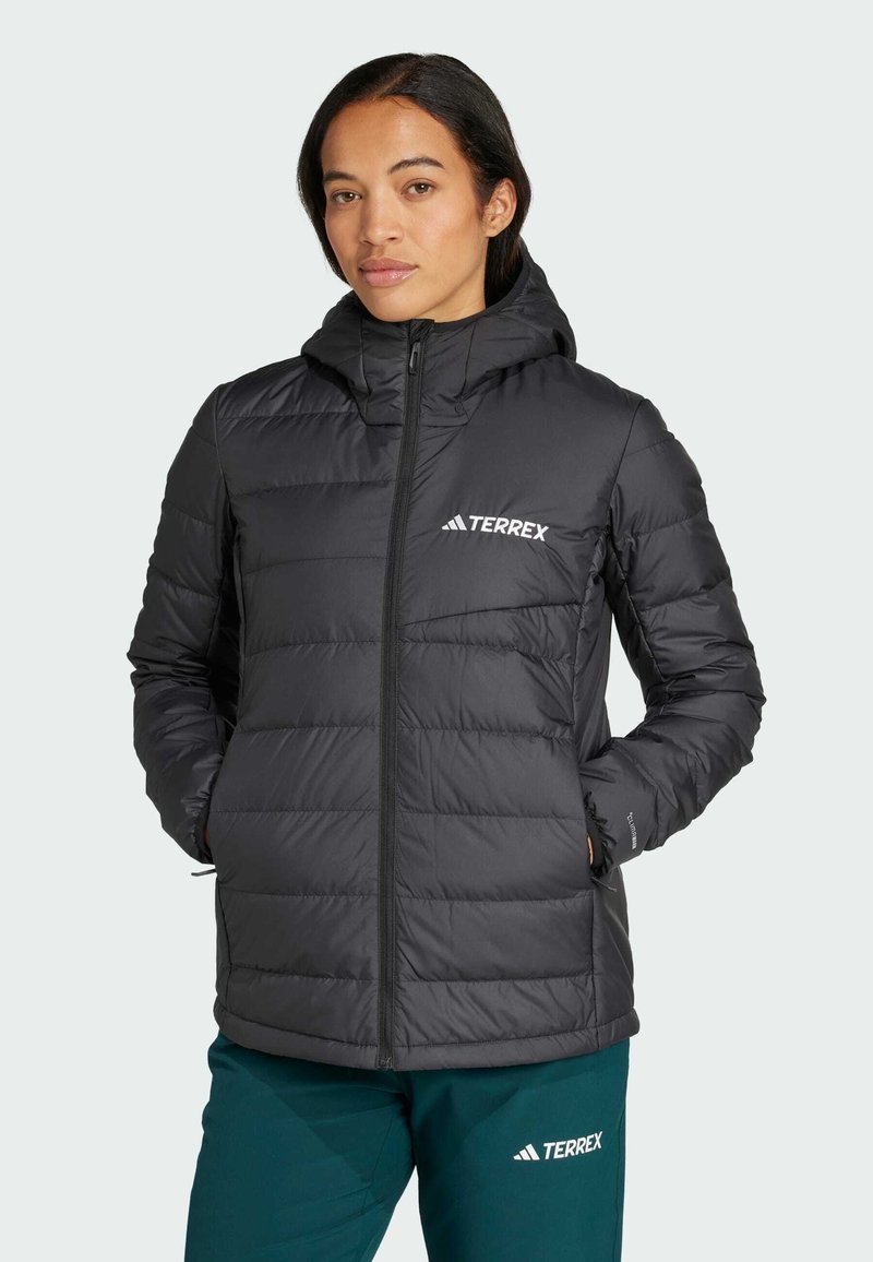 Black puffer jacket with a hood, features quilted texture, zip closure, and front pockets. Logo displayed on the chest.