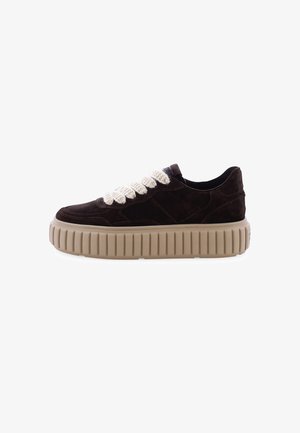 Brown suede sneaker with a thick, beige, ridged sole. It features a chunky, textured cream lace detail and a streamlined design.