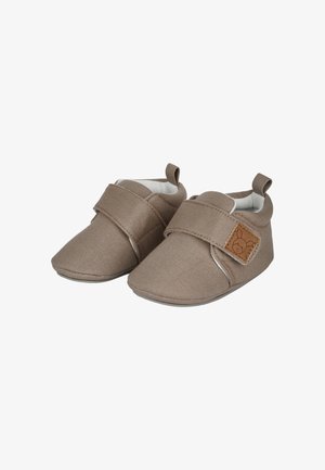 Brown fabric baby shoes with a Velcro strap, rounded toe, white lining, and a small bear logo on the side. Soft sole design.