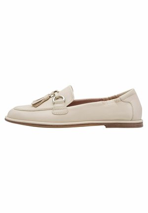 Beige leather loafers with a round toe, featuring a decorative tassel and circular hardware, and a flat brown sole. Smooth texture, simple design.