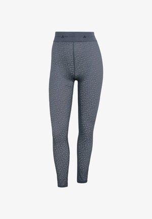 Leggings imprimé léopard gris en tissu texturé, dotés d'une ceinture élastique avec logo. Coupe près du corps et finition lisse.