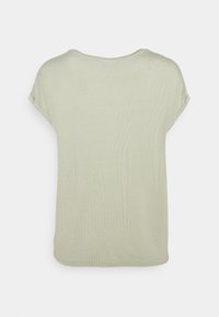 Maglietta leggera beige a maniche corte con risvolti, collo rotondo e orlo leggermente curvo, vista da dietro su sfondo bianco.