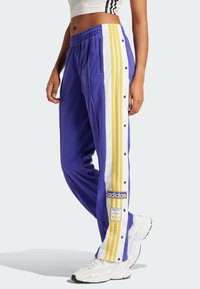 adidas Originals BREAK  - Tracksuit bottoms - energy ink   bold gold