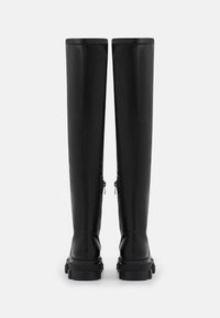 Black knee-high boots made of smooth material with side zippers, chunky soles, and minimal stitching detail. Vertical design, sleek shape.