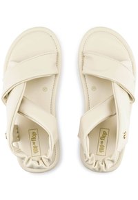 Beige flip-flop sandals with a soft, squishy texture. Crossed straps at the front and a ruffled back strap, featuring a logo detail. Size 37.