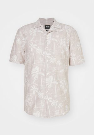 Camicetta a maniche corte in lino beige chiaro, con un motivo tropicale bianco di palme, fiori e velieri.