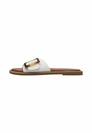 White slide sandal featuring a glossy, clear decorative buckle and brown leather insole. Textured outer sole with contrasting stitching detail.