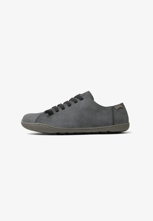 Gray suede shoes with a low profile, rounded toe, and gray laces. Features a simple design and minimal stitching along the sole.