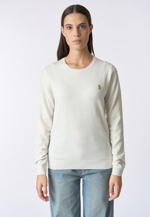 Maglione a maglia color crema con maniche lunghe, scollatura rotonda e orlo a coste. Presenta un piccolo logo ricamato sul lato sinistro del petto.