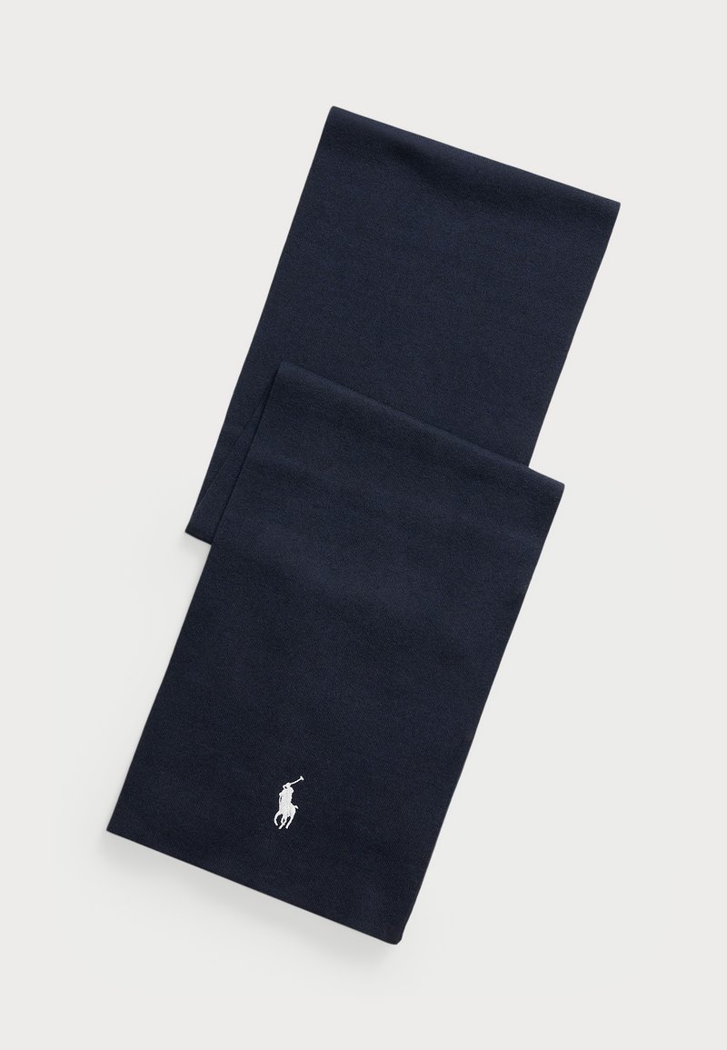 Tamsiai mėlynas šalikas, pagamintas iš minkštos medžiagos. Yra išsiuvinėtas baltas polo logotipas. Stačiakampio formos su apdirbtais kraštais.