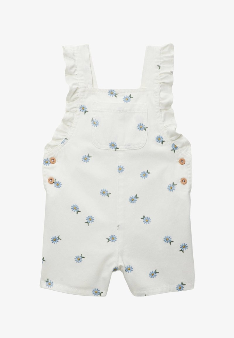 Combinaison blanche pour tout-petit avec bretelles volantées, poche poitrine devant, boutons latéraux et petit imprimé floral marguerite bleue partout.