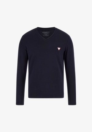 Tumesinine pikakätine V-kaelusega t-särk, mis on valmistatud puuvillast ning mille vasakul rinnal on väike punane kolmnurkne logo. Sile tekstuur, minimalistlik disain.