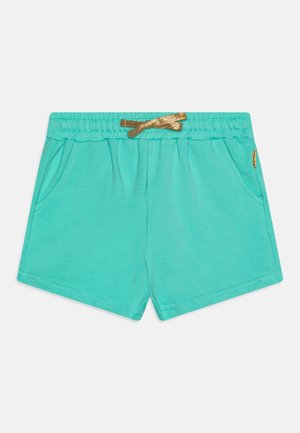 Short en coton turquoise avec ceinture élastique, cordon doré, poches latérales et petite étiquette logo sur la poche droite.