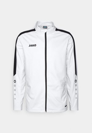 Witte sportjack met zwarte accenten, volledige rits, hoge kraag, JAKO-logo en knoopdetails op de mouwen. Slim fit en een gladde textuur.