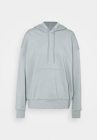 Jasnoszara, luźna bluza z kapturem, z przednią kieszenią kangurką, szczegółami w postaci sznurka i ściągaczami na rękawach oraz u dołu.