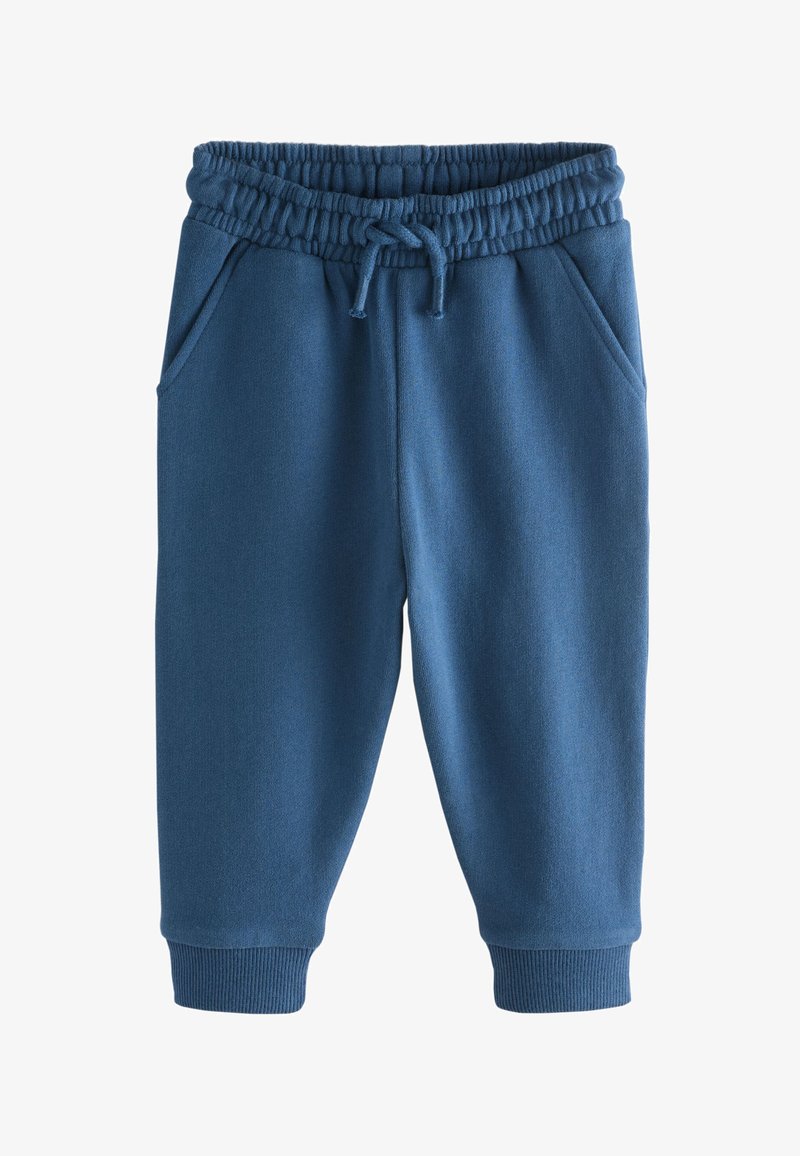 Pantaloni della tuta blu in cotone con vita elastica, coulisse, due tasche laterali e polsini a costine alla caviglia. Texture morbida, design semplice.