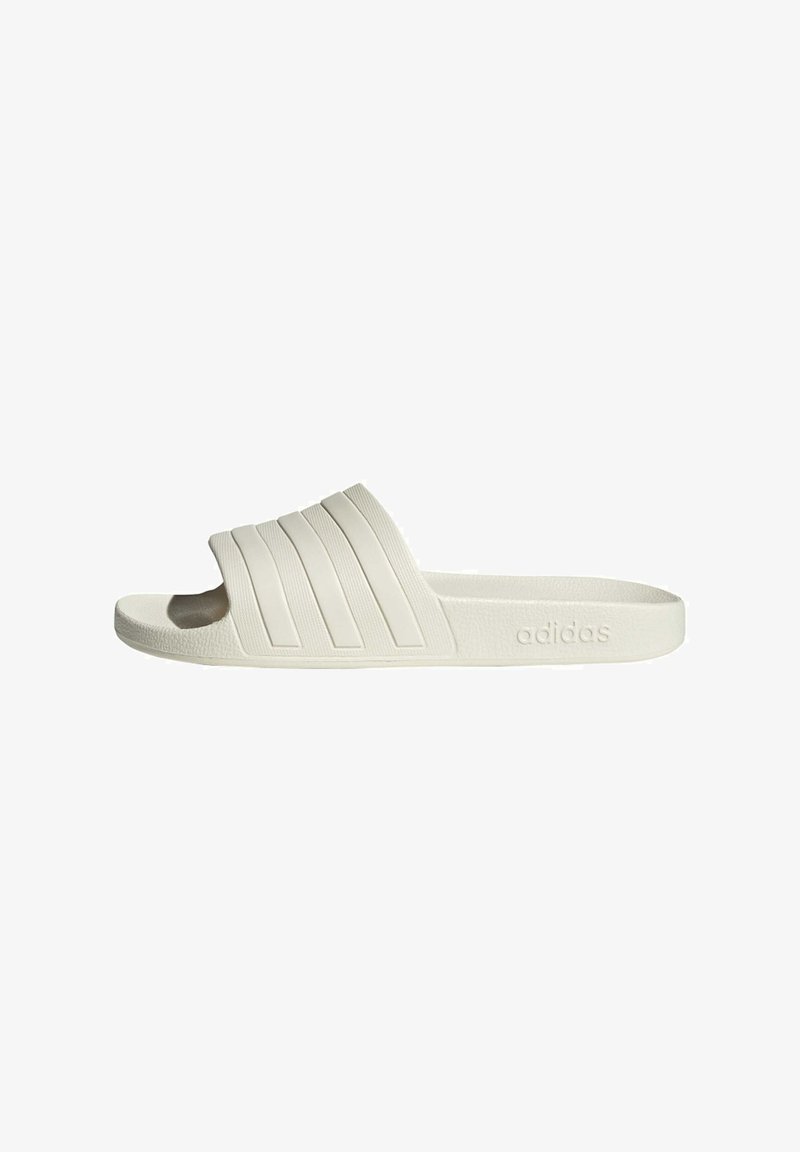 White slide sandal with a textured rubber sole, featuring three horizontal striped accents on the upper and the adidas logo embossed on the side.
