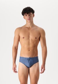 Blue swim briefs with a drawstring, medium coverage design, stretch fabric, smooth texture, and a low-rise waist.