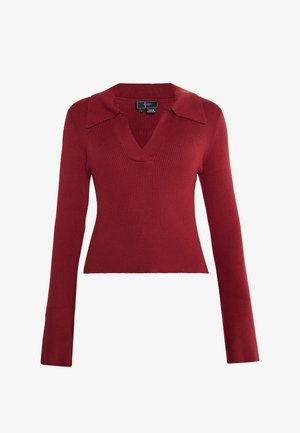 Rode geribde longsleeve trui met een diepe V-hals en kraag, getailleerde pasvorm en textuurstof. Etiket zichtbaar aan de binnenkant bij de halslijn.