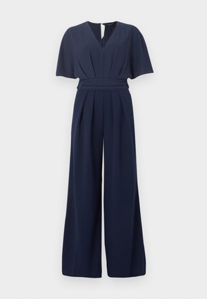 Laivastonsininen haalaripuku leveillä lahkeilla, lyhyillä liehukehihoilla, V-pääntiellä ja istuvalla vyötäröllä, jossa on laskoset edessä.