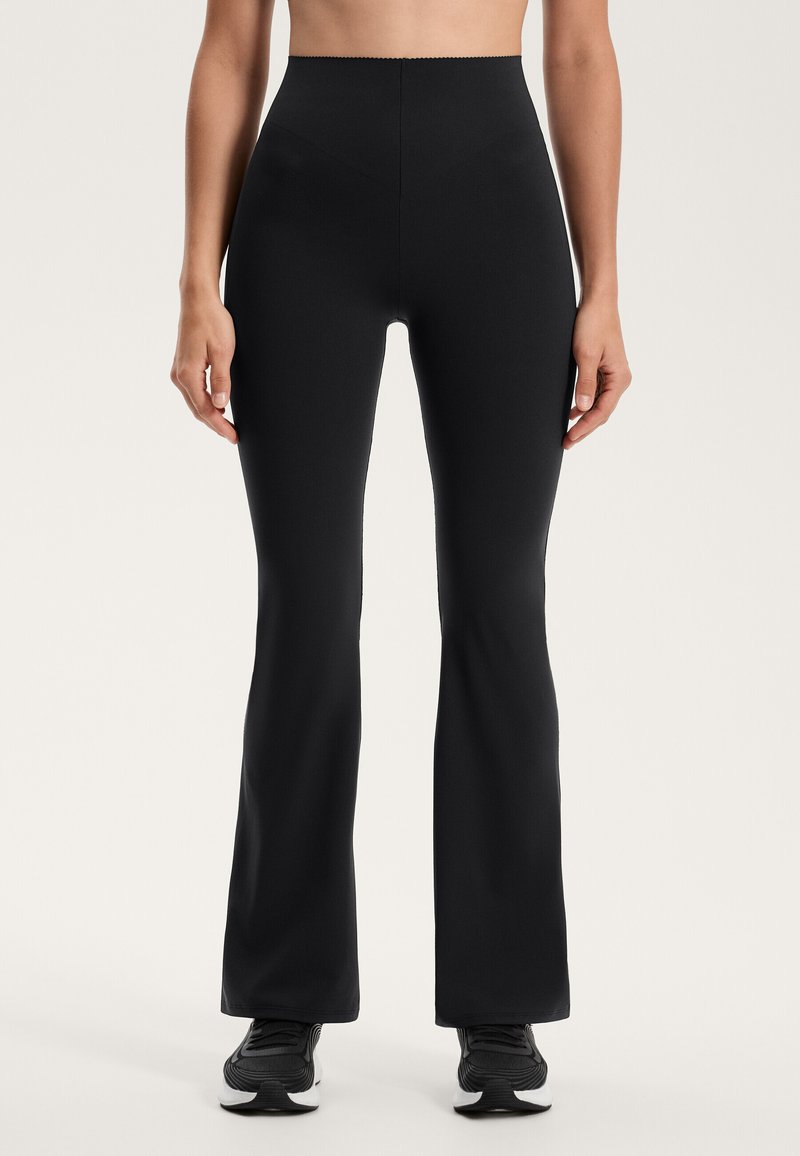 Fekete, bővülő leggings rugalmas anyagból, magas derékkal. Simás textúra és minimalista dizájn, látható logók nélkül.