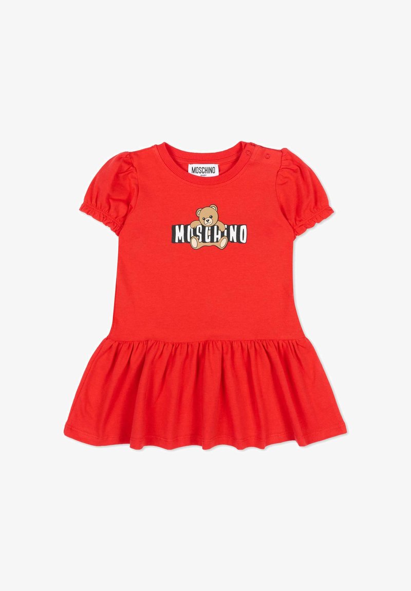 Robe bébé rouge avec manches bouffantes, jupe froncée et logo ourson au-dessus du texte "MOSCHINO" sur la poitrine, deux boutons sur l'épaule.