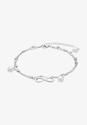 Bracelet en chaîne argentée avec un symbole de l'infini, des perles argentées rondes et des perles blanches, mettant en avant un design délicat et des détails élaborés.