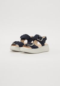 Navy blue platform sandals with two adjustable straps, silver buckle accents, and a textured white rubber sole. Smooth suede fabric.