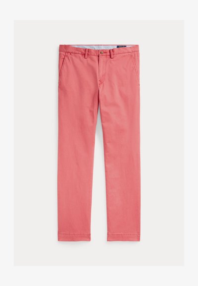 Medvilninės kelnės ryškių rožinių spalvų, su plokščiu priekiu, diržo kilpomis ir dviem šoninėmis kišenėmis. Tiesios kojos dizainas su apsiūtomis apatinėmis dalimis.