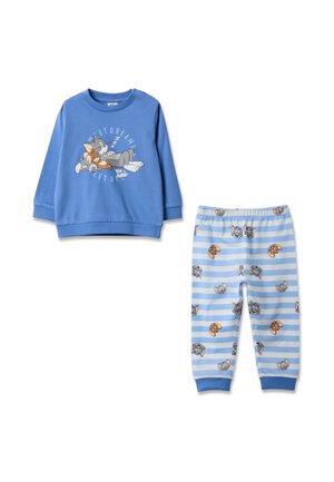 Blue long-sleeve top with sleeping Tom and Jerry print and matching striped pants featuring repeated Tom and Jerry faces in various expressions.