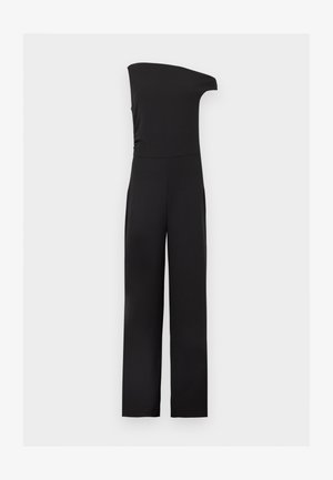 Combinaison noire sans manches avec design à une épaule et pantalon à jambes larges sur un fond clair uni.