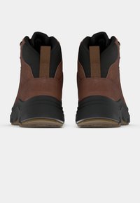 Pruun nahast pahkluu saapad musta kangast ülemise osa, kummist talla ja tagumise tõmblukuga, millel on tekstuuriga viimistlus ja tugevdatud õmblused.