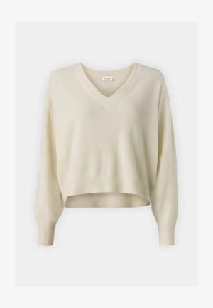 V veida kakla, īss džemperis no maigas, krēmkrāsas adītas auduma. Ar brīviem, gariem piedurknēm un ribotām aprocēm un apakšmalu.