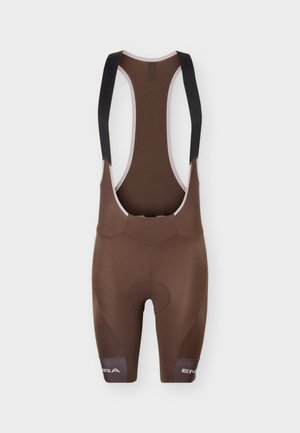 Cuissards de cyclisme marron avec bretelles noires et logo de marque réfléchissant sur les bas de jambes, présentés à plat sur fond blanc.