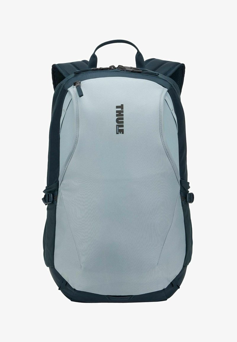 Sac à dos Thule gris et noir avec poignée supérieure, bretelles rembourrées et compartiments fermés par zip.