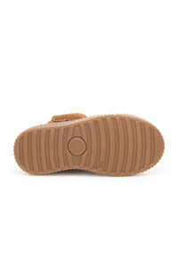 Rubberen zool met horizontale groeven, cirkelvormige knopdetails, beige kleur en een licht verhoogde rand. Het bovenste gedeelte is oranje met een band.